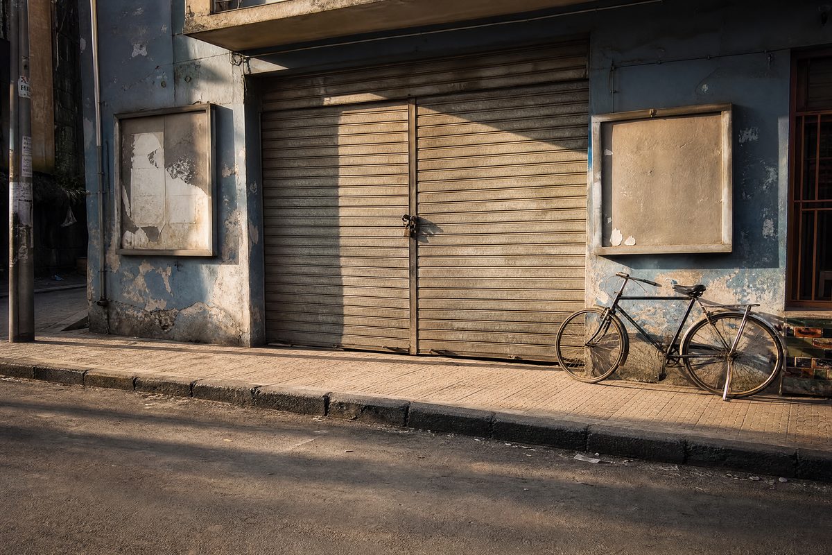Closed metal shutter, padlock, empty poster frames